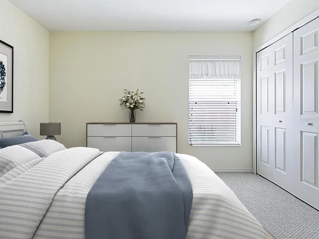 a view of a room with wooden floor and ceiling fan