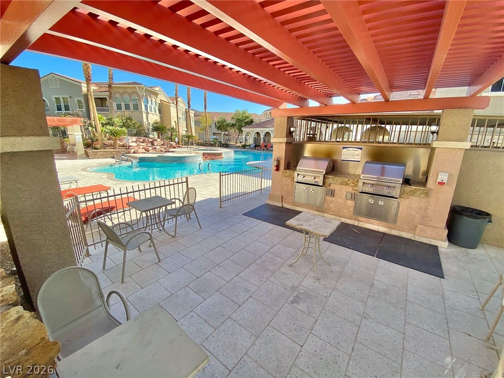 10550 West Alexander Road, Unit 1131 Las Vegas, NV 89129 - Photo 16 of 18 An inviting outdoor cooking and dining space awaits by the resort-style pool.