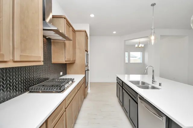 a kitchen with a sink a counter space and a refrigerator
