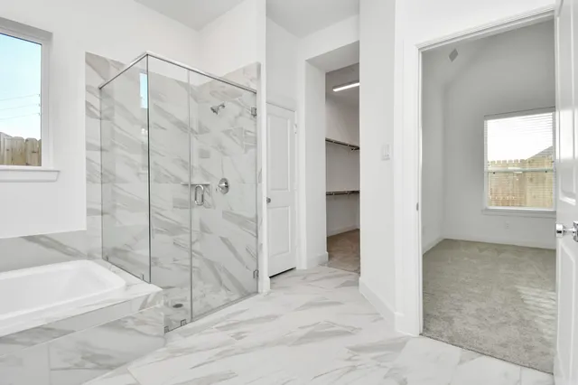 a bathroom with a granite countertop sink a mirror and a bathtub