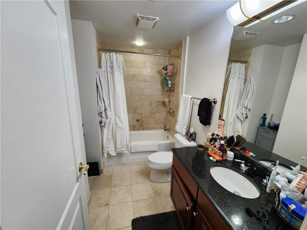 195 14th Street Northeast, Unit 304 Atlanta, GA 30309 - Photo 16 of 25 a bathroom with a double vanity sink toilet mirror and shower
