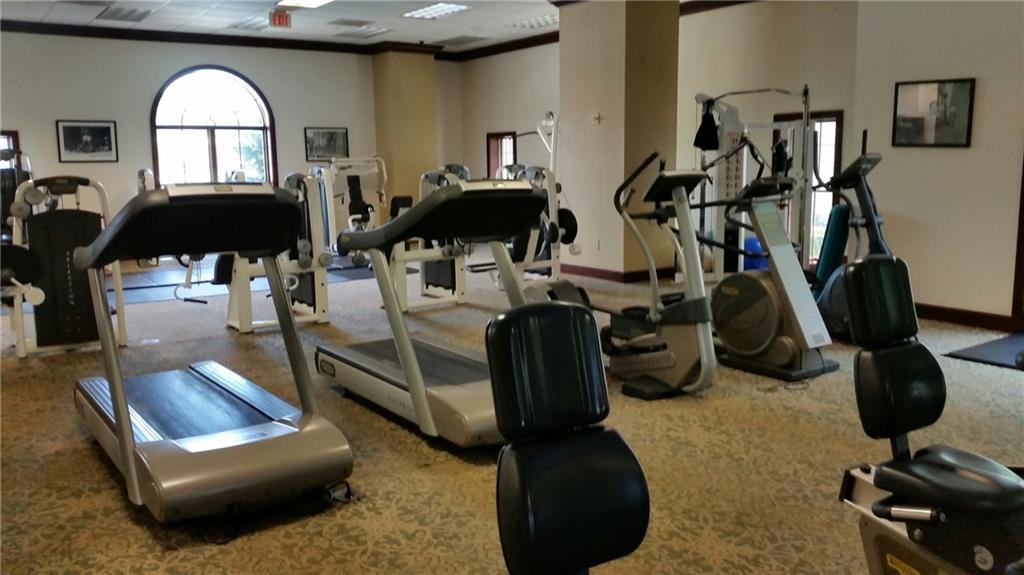 195 14th Street Northeast, Unit 304 Atlanta, GA 30309 - Photo 18 of 25 a living room with furniture a window and gym equipment