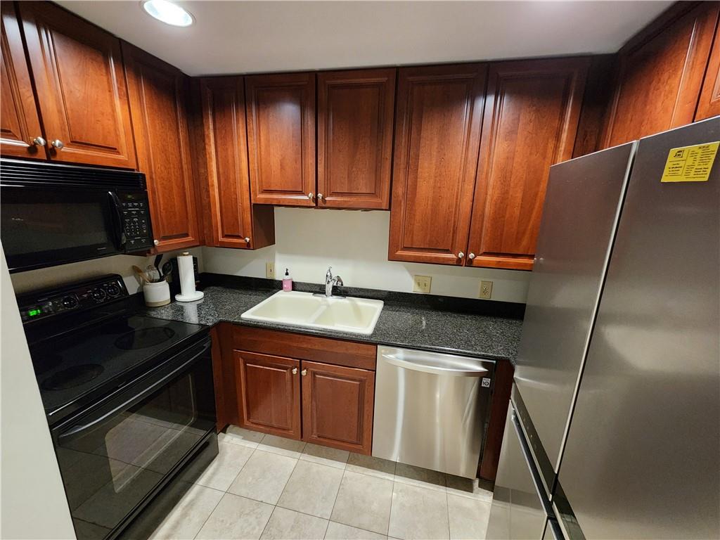 195 14th Street Northeast, Unit 304 Atlanta, GA 30309 - Photo 10 of 25 a kitchen with a cabinets appliances and cabinets