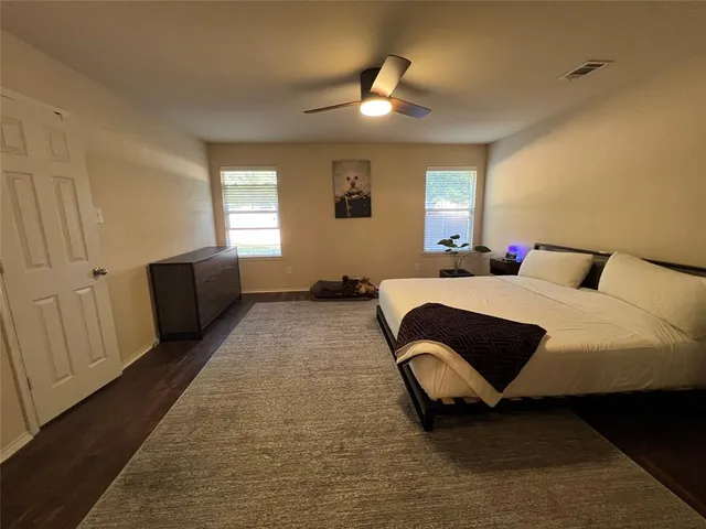 a bedroom with a bed and window