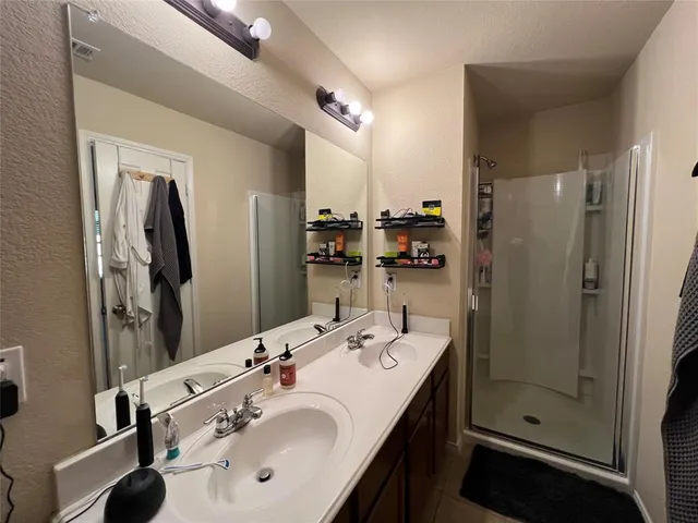 a bathroom with a sink double vanity and shower