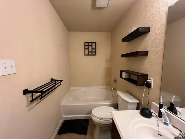 a bathroom with a sink a toilet and a bathtub