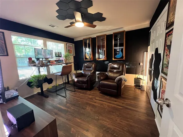 a living room with furniture fireplace and a large window