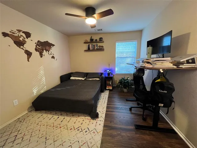 a bedroom with a bed closet and a flat tv screen