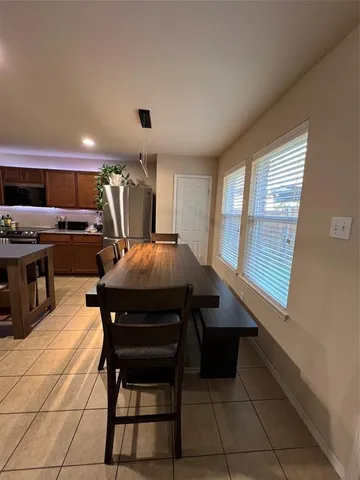 a view of a dining room with furniture and a window