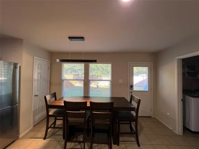 a view of a dining room with furniture and a window