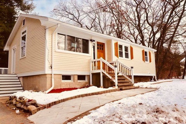 144 Salem Road Billerica, MA 01821 - Photo 1 of 16 a front view of a house with a yard covered with snow and trees