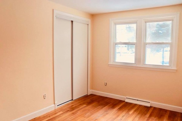 144 Salem Road Billerica, MA 01821 - Photo 11 of 16 an empty room with wooden floor and windows