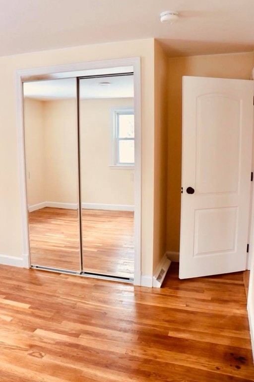 144 Salem Road Billerica, MA 01821 - Photo 16 of 16 an empty room with wooden floor and windows