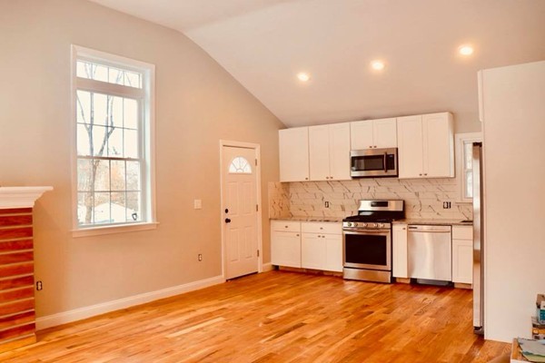 144 Salem Road Billerica, MA 01821 - Photo 3 of 16 a kitchen with stainless steel appliances granite countertop a stove a sink and a refrigerator