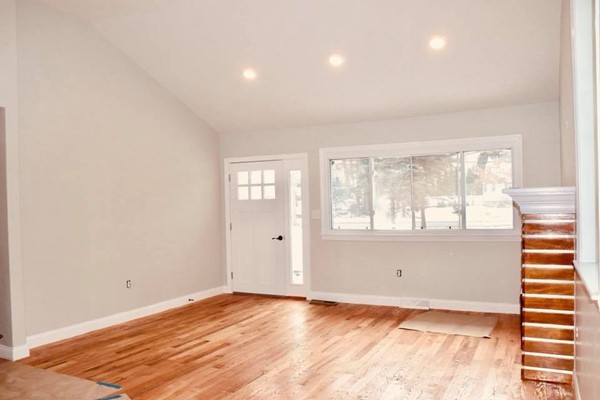144 Salem Road Billerica, MA 01821 - Photo 6 of 16 an empty room with wooden floor and windows