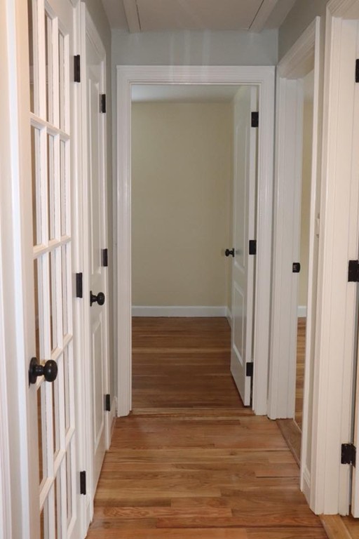 144 Salem Road Billerica, MA 01821 - Photo 7 of 16 a view of a hallway with wooden floor and staircase