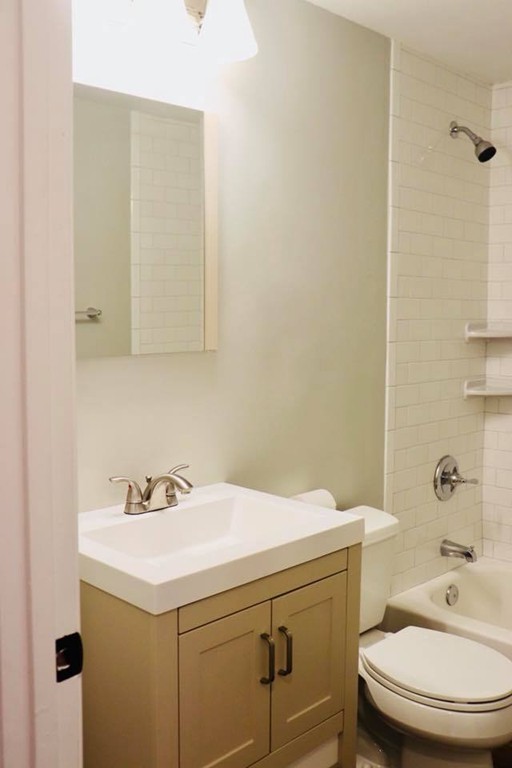 144 Salem Road Billerica, MA 01821 - Photo 8 of 16 a bathroom with a sink a toilet and a mirror