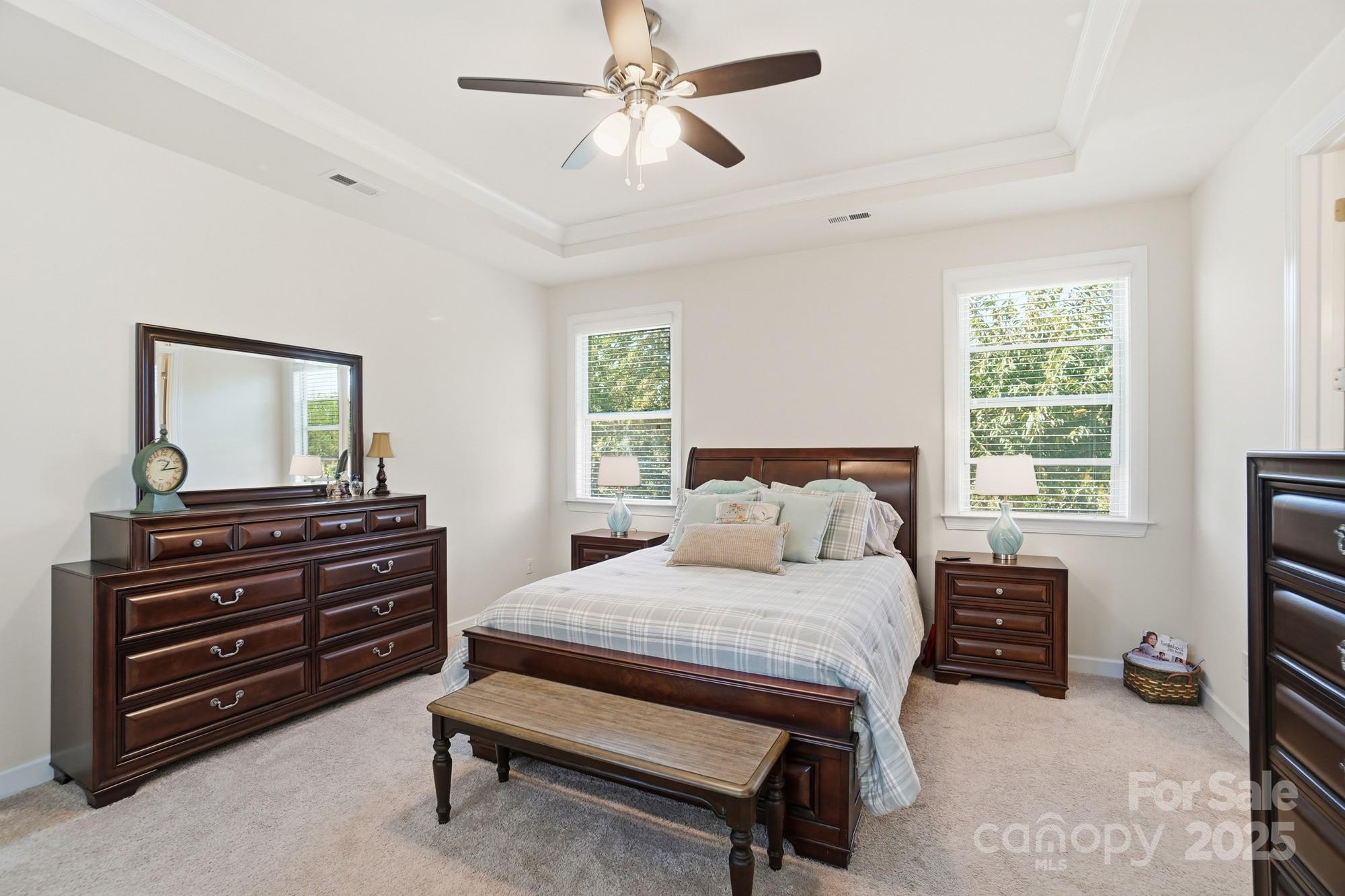 1296 Independence Street Tega Cay, SC 29708 - Photo 13 of 27 a bedroom with a bed and a flat tv screen on dresser