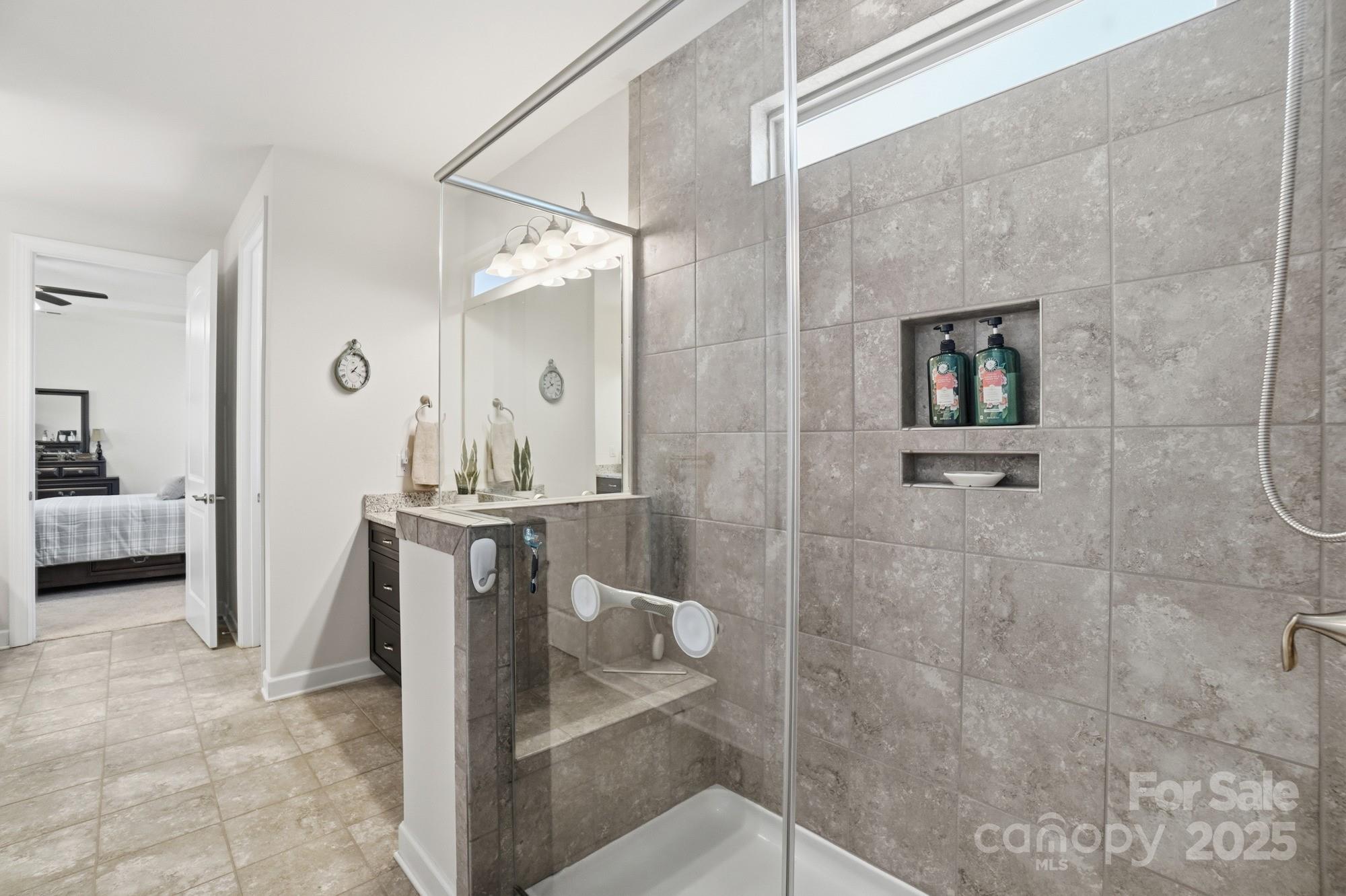 1296 Independence Street Tega Cay, SC 29708 - Photo 15 of 27 a bathroom with a sink a toilet and shower