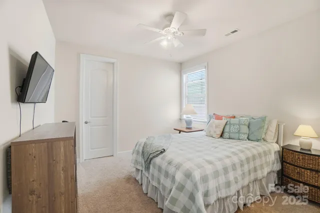 a bedroom with a bed and a chair