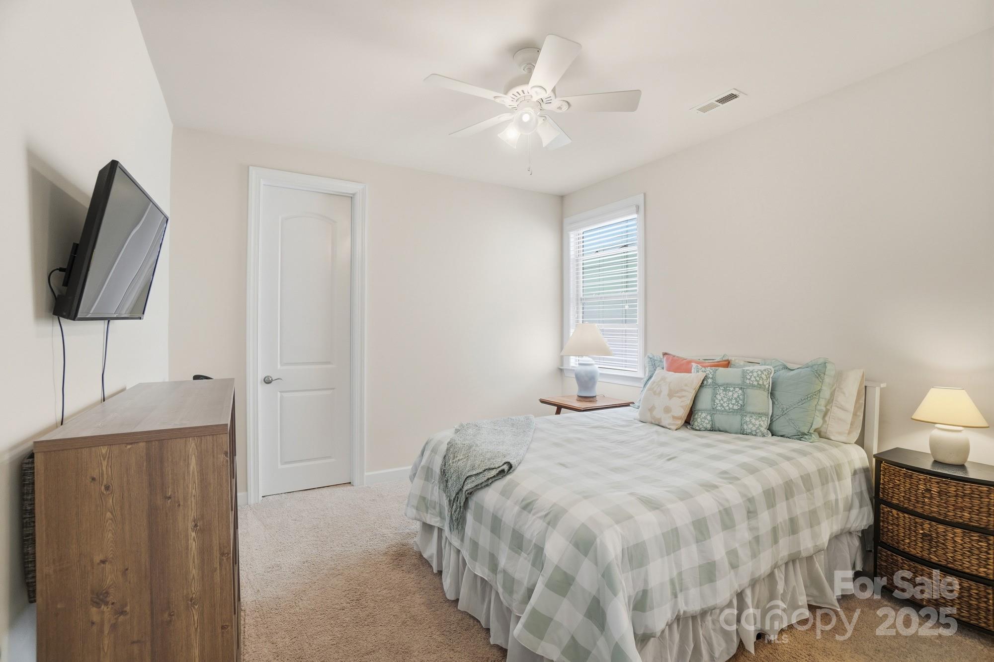 1296 Independence Street Tega Cay, SC 29708 - Photo 16 of 27 a bedroom with a bed and a chair