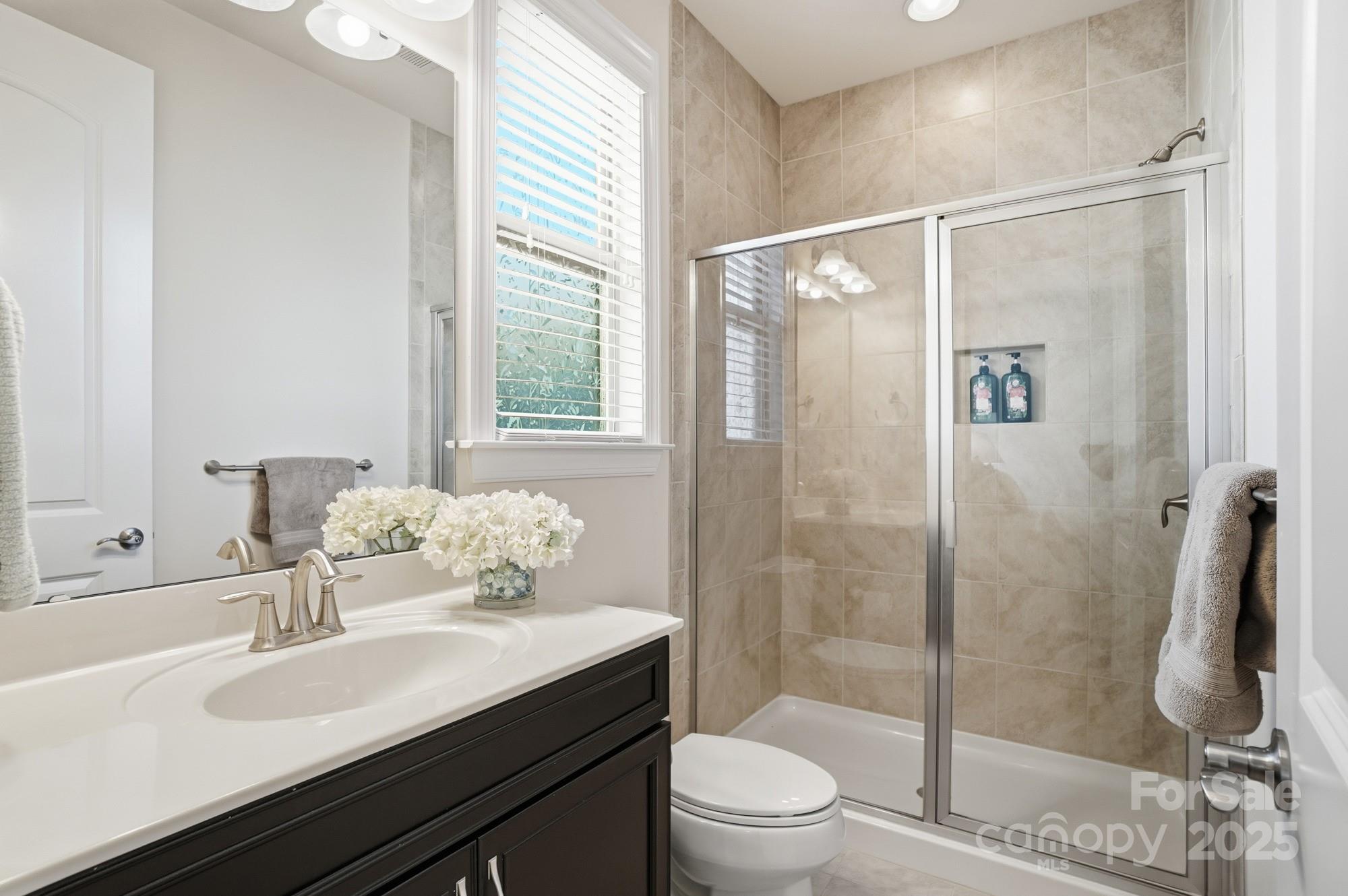 1296 Independence Street Tega Cay, SC 29708 - Photo 17 of 27 a bathroom with a sink toilet and shower