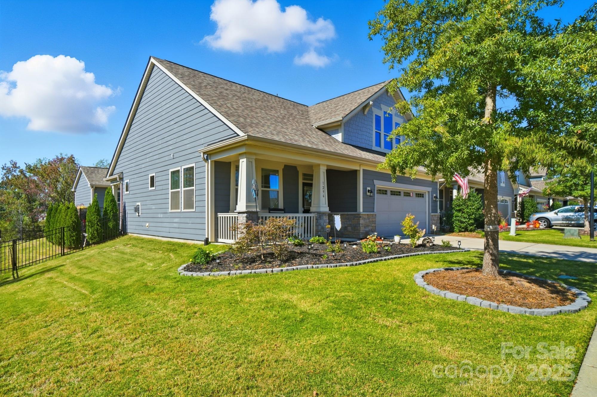 1296 Independence Street Tega Cay, SC 29708 - Photo 2 of 27 a front view of house with yard and green space