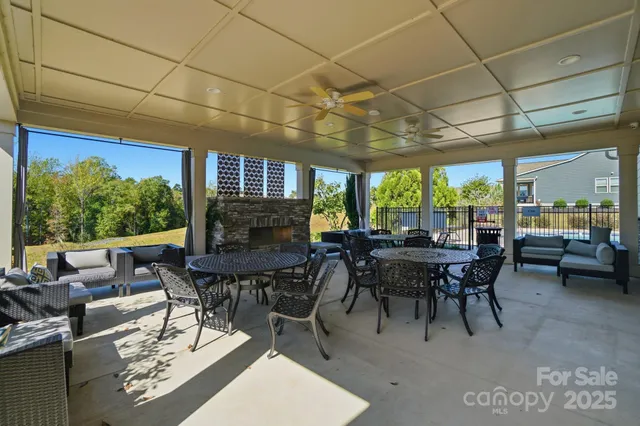 a view of a patio with table and chairs and potted plants