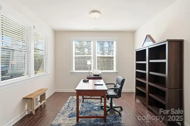 a dining room with furniture and windows
