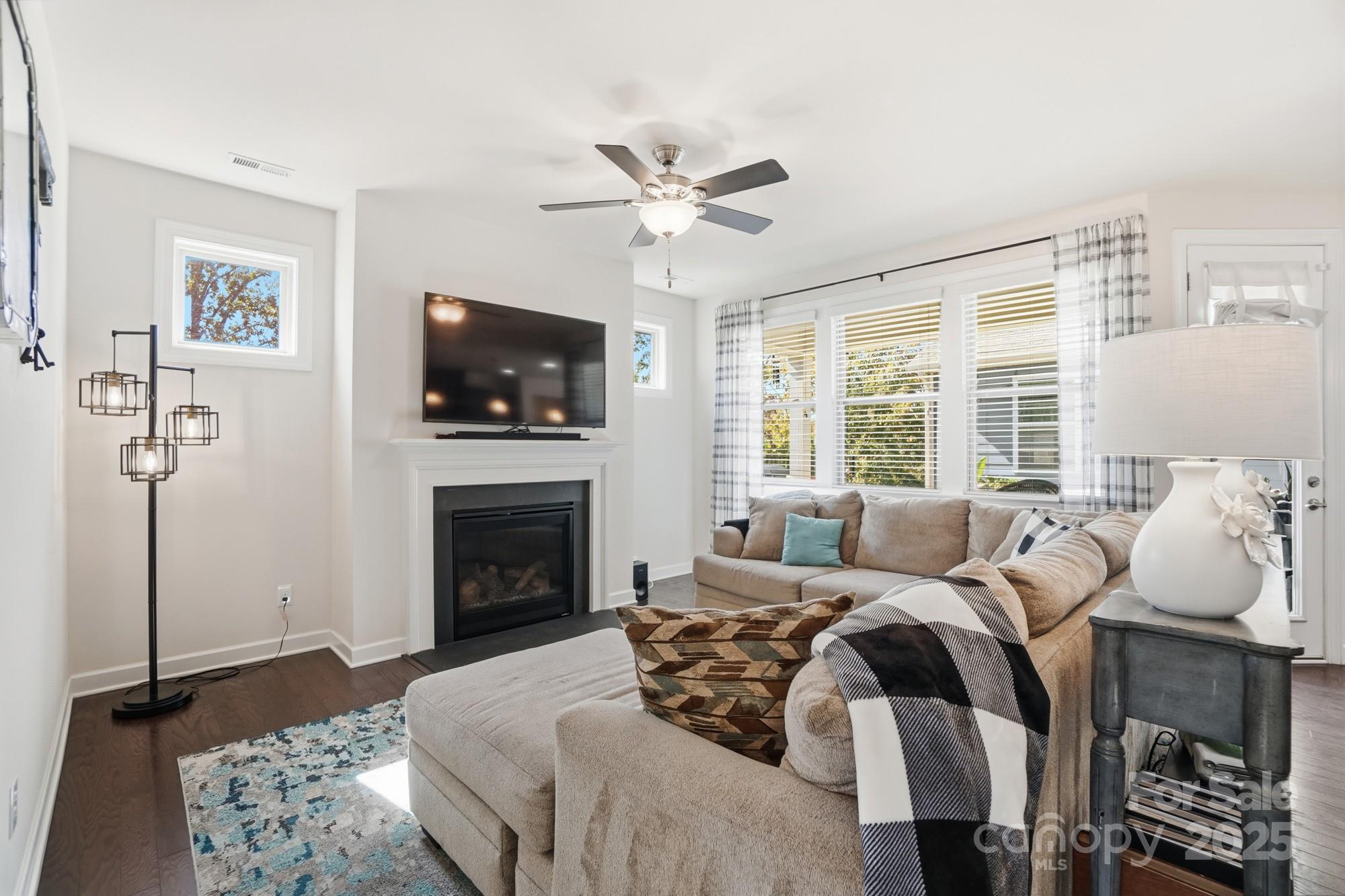 1296 Independence Street Tega Cay, SC 29708 - Photo 6 of 27 a living room with furniture a flat screen tv and a fireplace