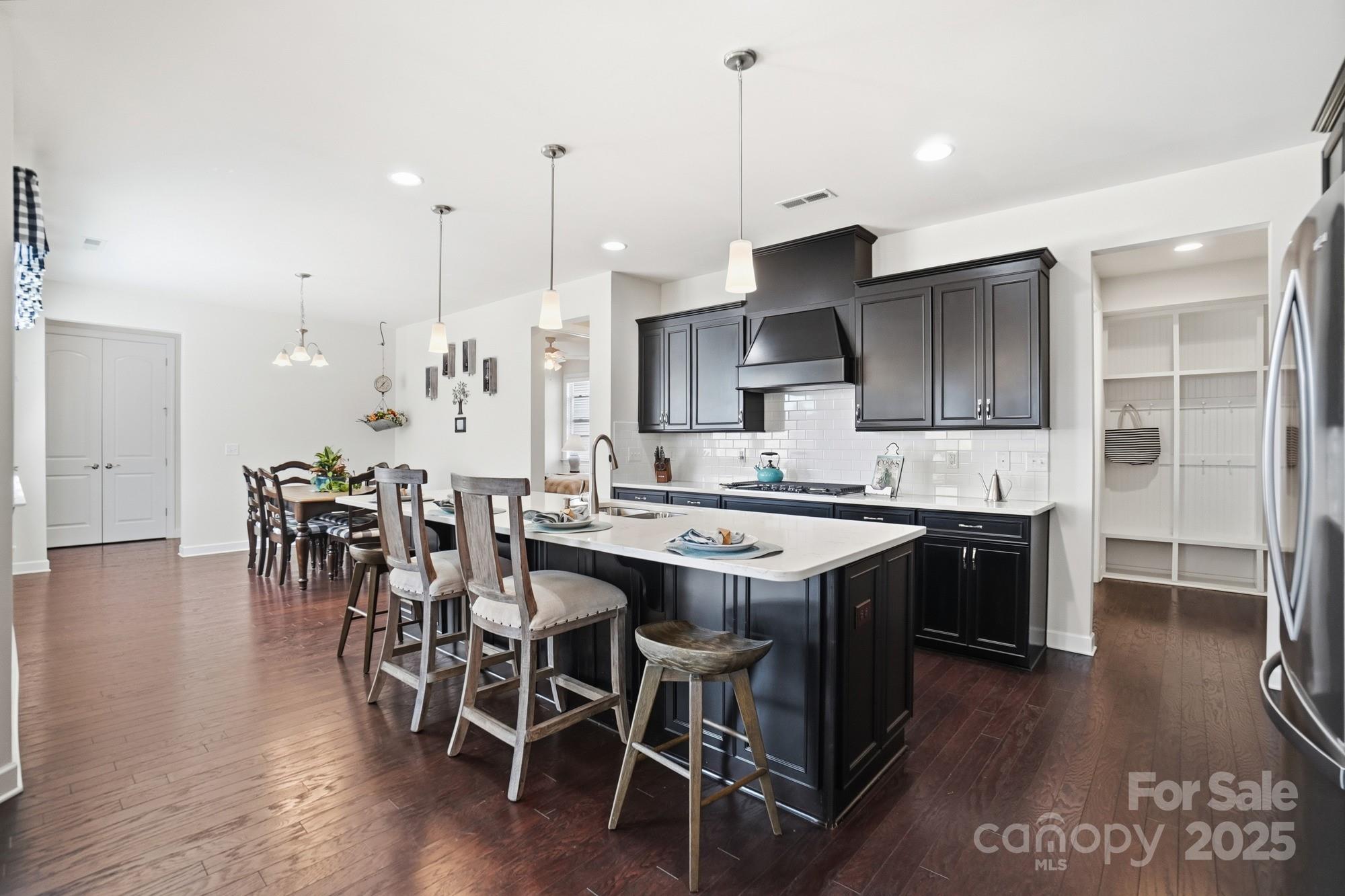 1296 Independence Street Tega Cay, SC 29708 - Photo 8 of 27 a kitchen with stainless steel appliances granite countertop a table chairs sink and cabinets