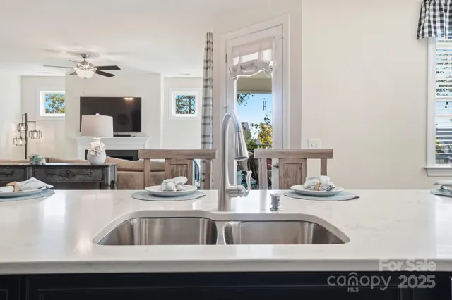a kitchen with a sink and a mirror