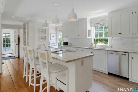 a kitchen with granite countertop cabinets and window