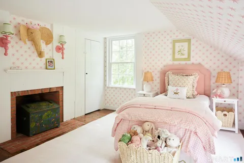 a bedroom with a bed and a fireplace
