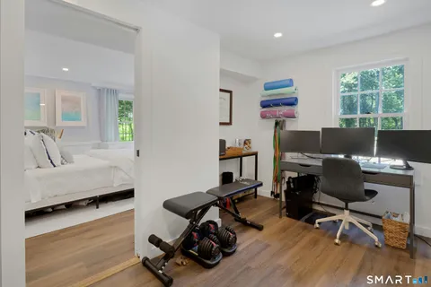 a view of a workspace with furniture and a window