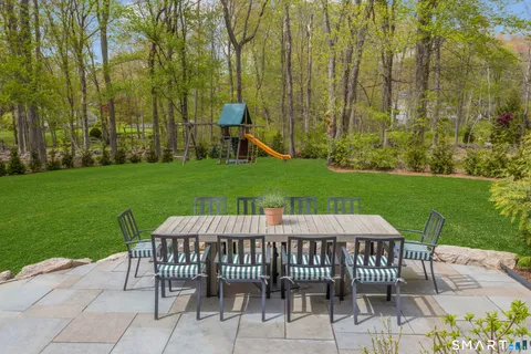a view of a patio with a table and chairs