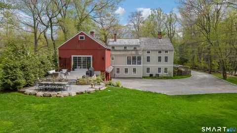 a view of a house with a yard and sitting area