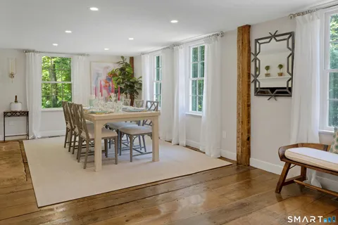 a view of a dining room with furniture and a potted plant