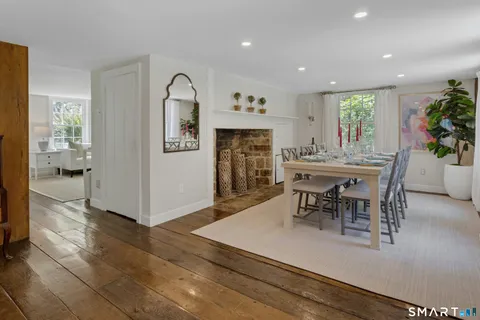 a view of a a dining room with furniture window and wooden floor