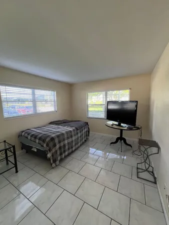 a bedroom with a bed and a chair in it