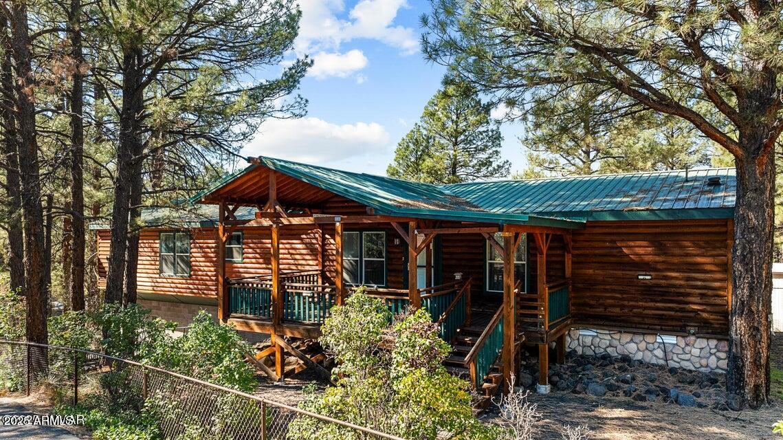 2421 West Thornton Road Show Low, AZ 85901 - Photo 5 of 48 a view of a house with a tree and wooden fence