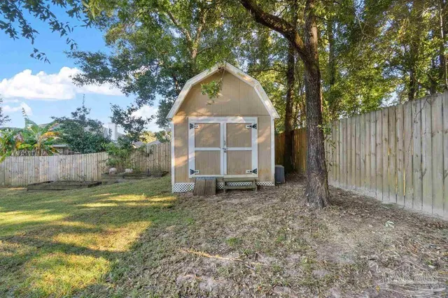 a view of a house with backyard and trees