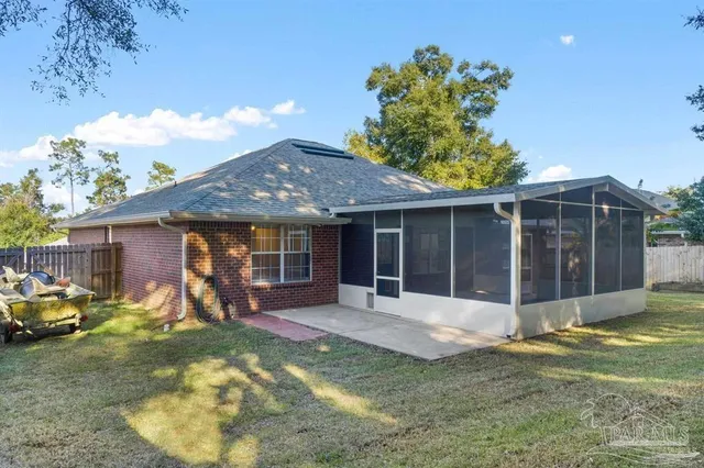 a view of a house with backyard and porch