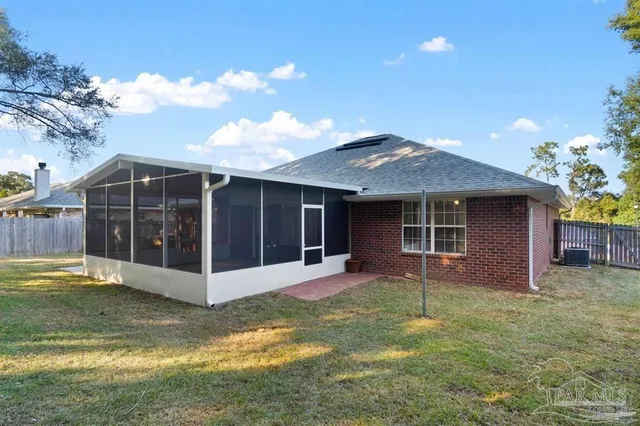 a view of a house with a yard and sitting area