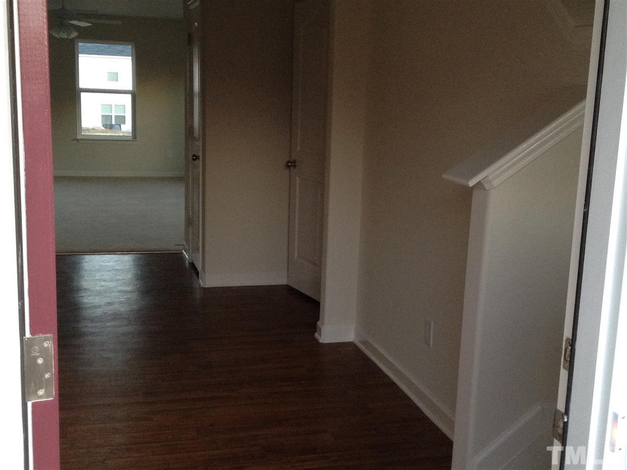6816 Planting Court Raleigh, NC 27610 - Photo 3 of 6 a view of a hallway with wooden floor