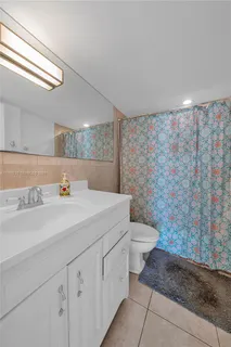 a bathroom with a sink a toilet and mirror
