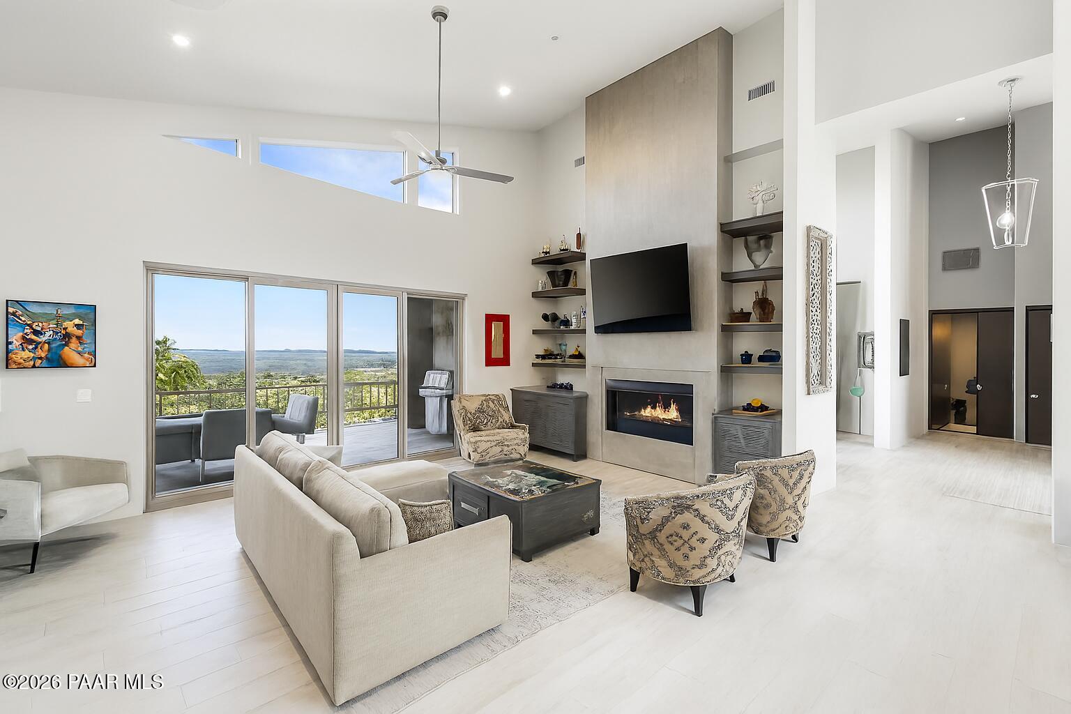 5245 West Three Forks Road Prescott, AZ 86305 - Photo 16 of 68 a living room with furniture a fireplace and a flat screen tv