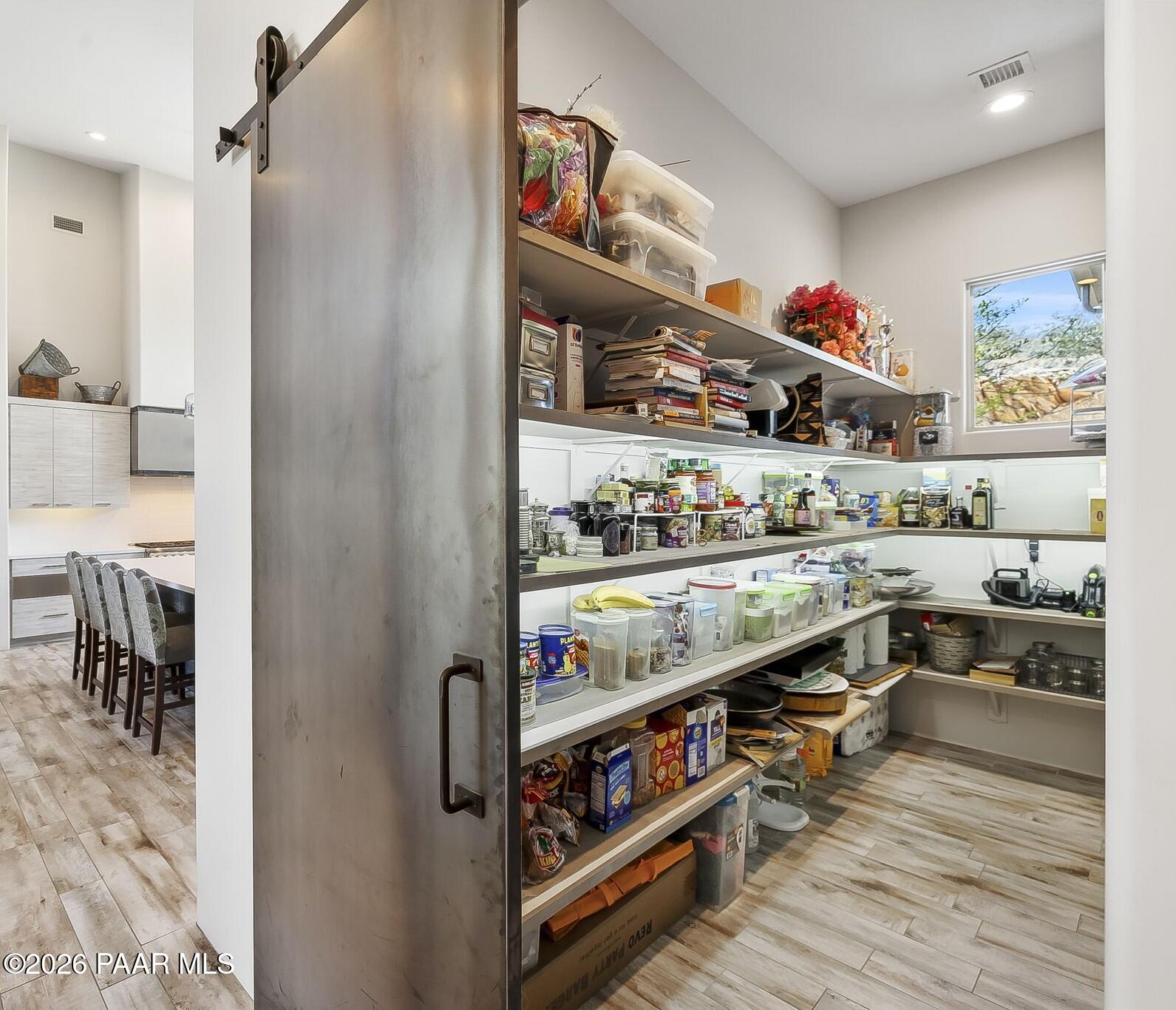 5245 West Three Forks Road Prescott, AZ 86305 - Photo 25 of 68 a kitchen with stainless steel appliances granite countertop a refrigerator and wooden floor
