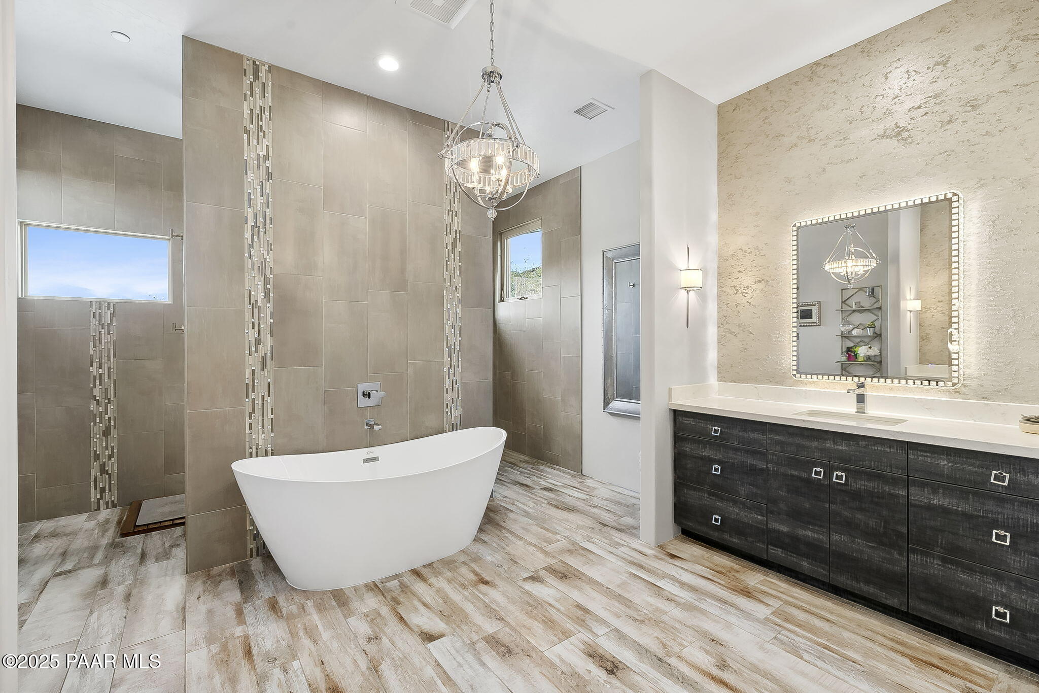 5245 West Three Forks Road Prescott, AZ 86305 - Photo 30 of 68 a spacious bathroom with a bathtub sink and mirror