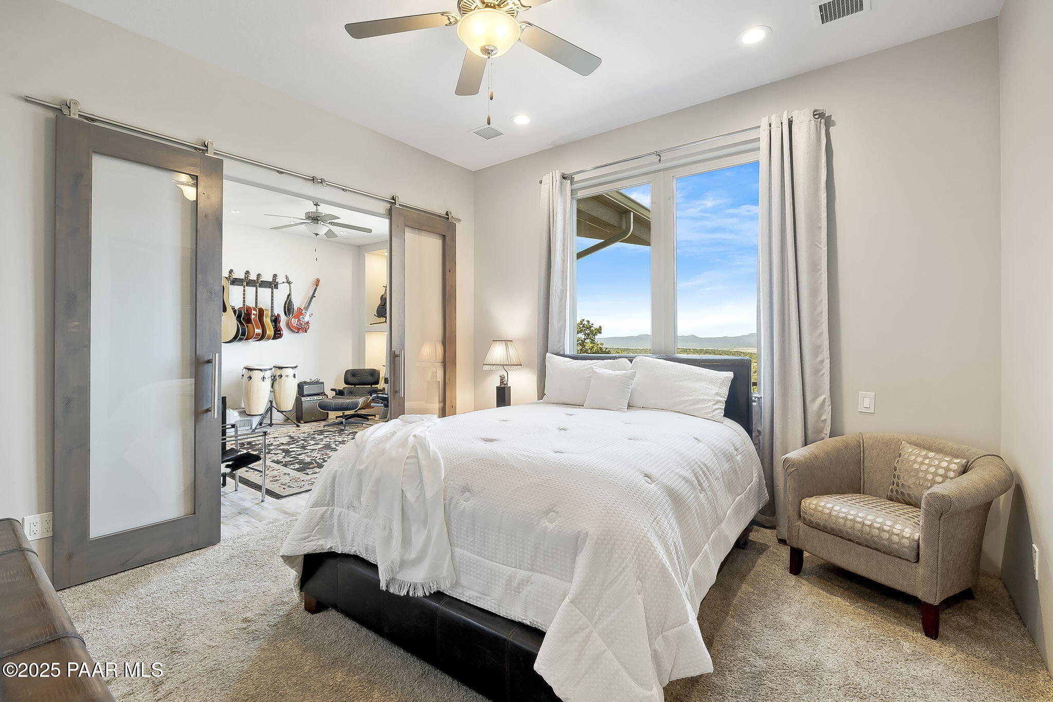 5245 West Three Forks Road Prescott, AZ 86305 - Photo 40 of 68 a bedroom with a bed couch and window